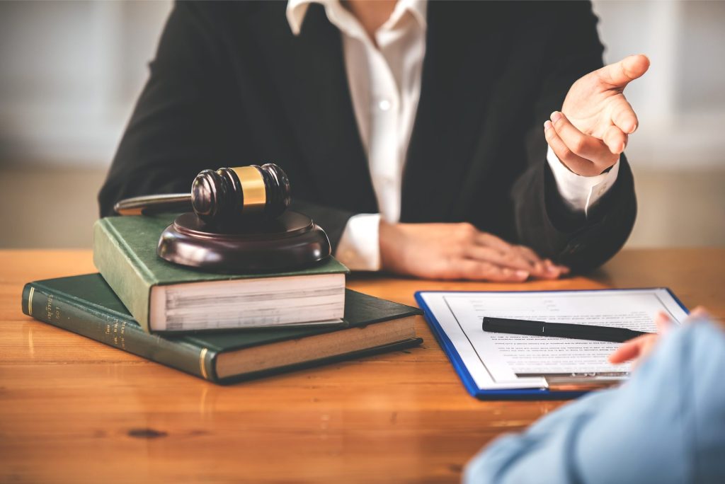 Gavel with law books and person sitting