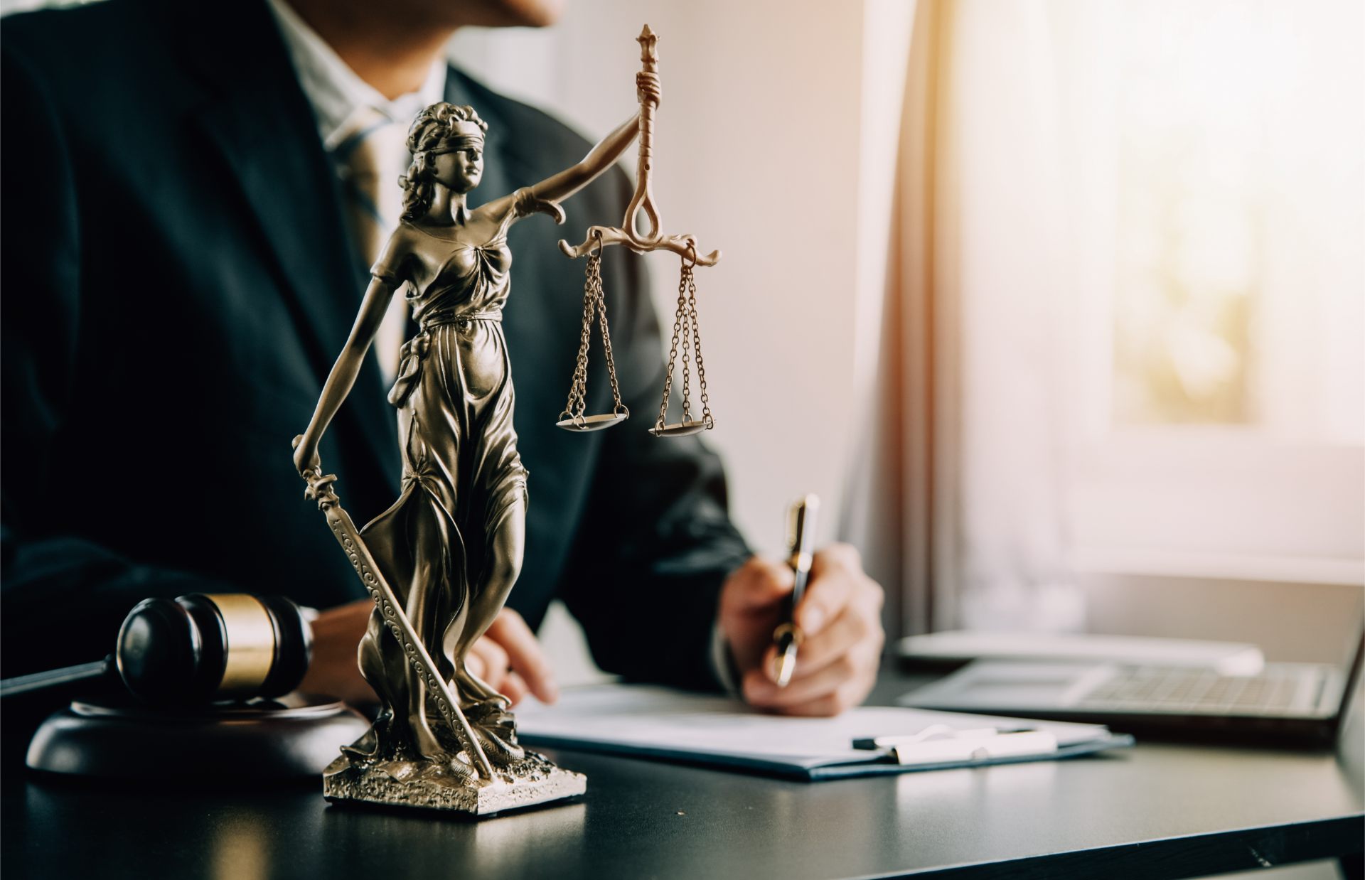 Lawyer with lady justice statue in his office